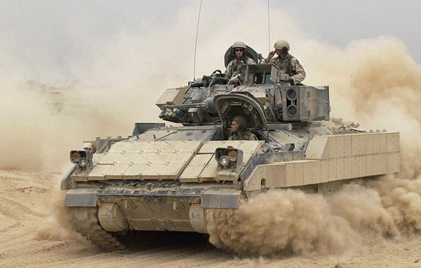 Photo: An M2A2 Bradley Fighting Vehicle kicks up plumes of dust as it leaves Forward Operating Base MacKenzie in Iraq for a mission on Oct. 30, 2004. The Bradley is assigned to Alpha Troop, 1st Battalion, 4th Cavalry Regiment, 1st Infantry Division.