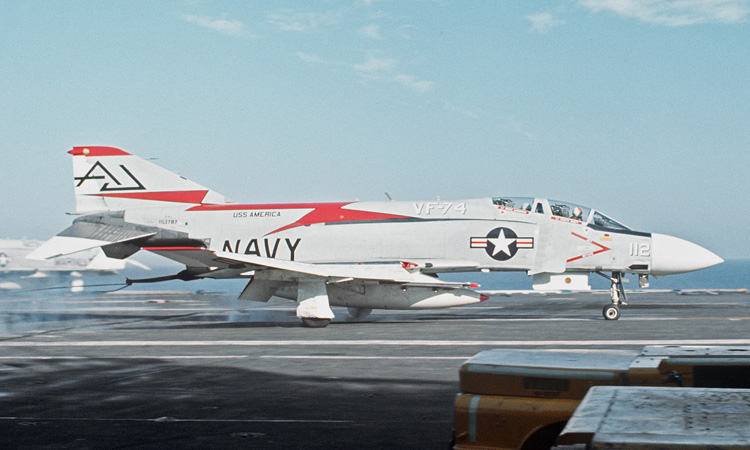 A U.S. Navy McDonnell Douglas F-4J Phantom II from fighter squadron VF-74 Be-Devilers of Attack Carrier Air Wing Eight (CVW-8) lands aboard the aircraft carrier USS America (CVA-66) off Vietnam in 1972/73